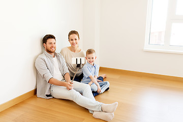 Image showing family taking selfie by smartphone at new home