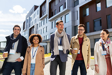 Image showing people with coffee and conference badges in city