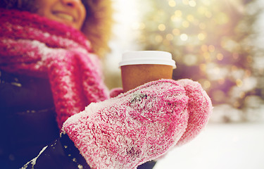 Image showing close up of hand with coffee outdoors in winter