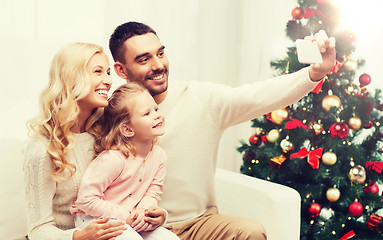 Image showing family taking selfie with smartphone at christmas