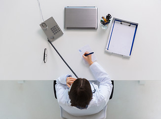 Image showing doctor with prescription calling on phone