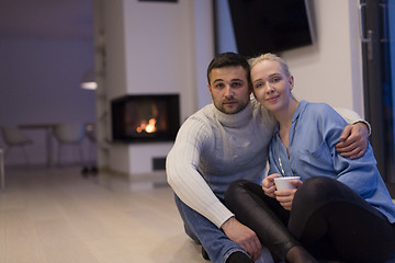 Image showing happy couple in front of fireplace