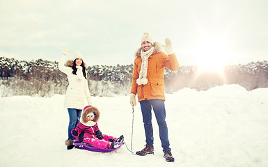 Image showing happy family with sled walking in winter outdoors