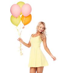 Image showing happy woman in dress with helium air balloons