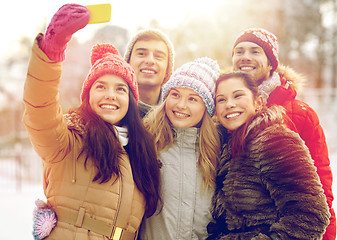 Image showing happy friends taking selfie with smartphone