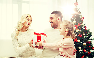 Image showing happy family at home with christmas gift box