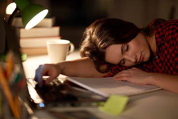 Image showing student or woman sleeping on table at night home