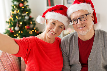 Image showing happy senior couple taking christmas selfie