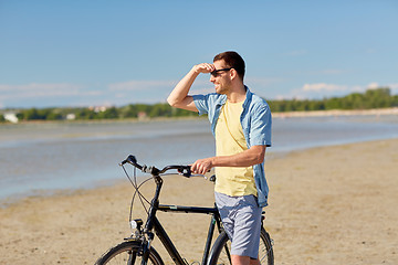 Image showing happy man with bicycle on summer beach