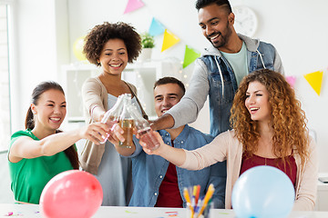 Image showing happy team with drinks celebrating at office party