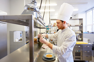 Image showing happy male chef cooking at restaurant kitchen