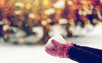 Image showing close up of woman holding snow outdoors