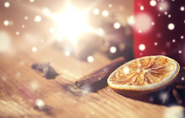 Image showing cinnamon, anise and dried orange on wooden board