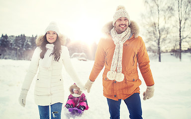 Image showing happy family with sled walking in winter outdoors