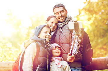 Image showing happy family with smartphone selfie stick in woods