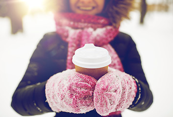 Image showing close up of hand with coffee outdoors in winter