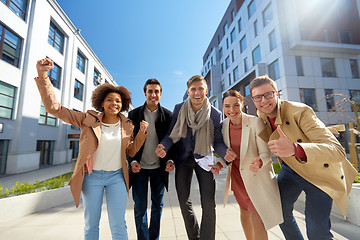 Image showing group of people showing thumbs up in city