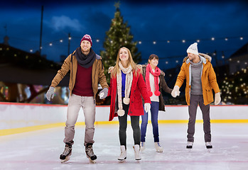 Image showing happy friends on christmas skating rink