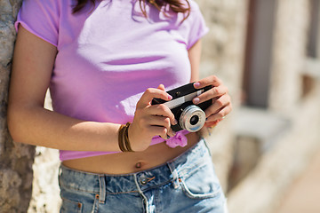 Image showing close up of woman with vintage camera outdoors