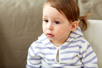 Image showing portrait of baby girl sitting on sofa at home