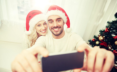 Image showing couple taking selfie with smartphone at christmas