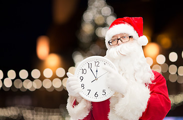 Image showing santa claus with clock pointing finger to twelve