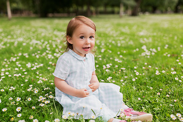 Image showing happy baby girl on green summer field