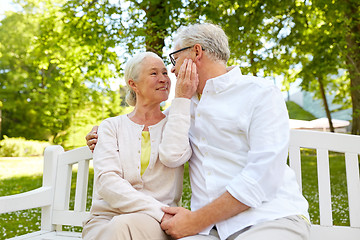 Image showing happy senior couple hugging in city park