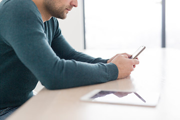 Image showing Young casual businessman using smartphone