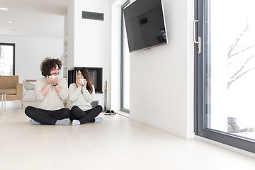 Image showing happy multiethnic couple  in front of fireplace