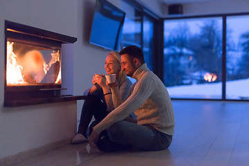 Image showing happy couple in front of fireplace