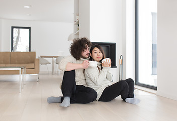 Image showing happy multiethnic couple  in front of fireplace