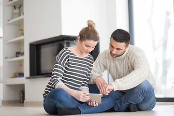 Image showing Young Couple using digital tablet on cold winter day