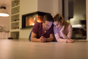 Image showing Young Couple using digital tablet on cold winter night