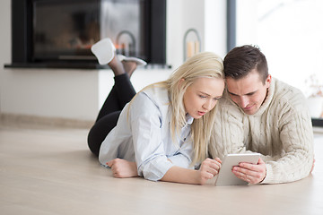 Image showing Young Couple using digital tablet on cold winter day