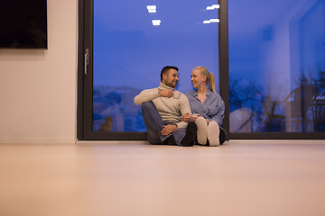 Image showing happy couple in front of fireplace