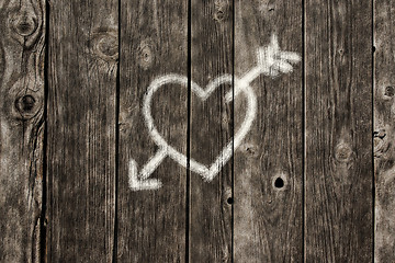 Image showing painted heart with arrow on old wooden planks