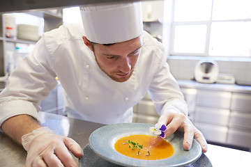 Image showing happy male chef cooking food at restaurant kitchen