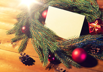 Image showing natural green fir wreath with note on wooden board