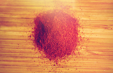 Image showing cayenne pepper or paprika powder on wood