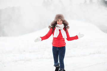 Image showing happy woman in winter fur hat outdoors