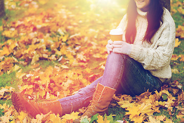 Image showing close up of woman drinking coffee in autumn park