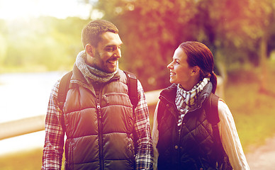 Image showing happy family walking with backpacks in woods