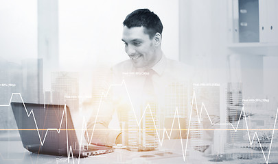 Image showing smiling businessman with laptop and documents