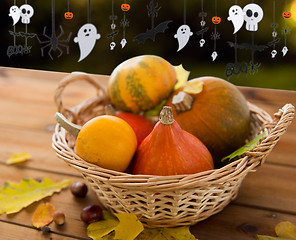 Image showing pumpkins in basket and halloween party garland