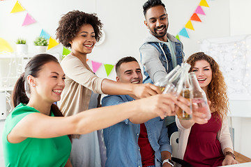 Image showing happy team with drinks celebrating at office party