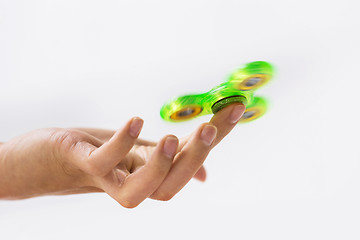 Image showing close up of hand playing with fidget spinner