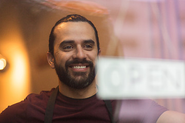 Image showing man with open banner at bar or restaurant window
