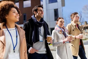 Image showing people with coffee and conference badges in city