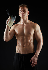 Image showing young man or bodybuilder with protein shake bottle
